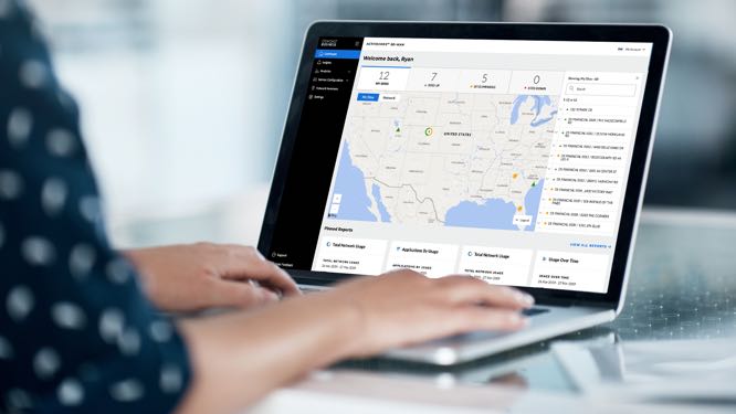 overs-shoulder view of a laptop screen showing a U.S. map, with ActiveCore network information running across the right side and bottom